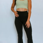 Model wearing The Sweat Society's soft yoga flared leg pants.