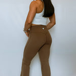 Model turned to the side showing the backside design of the soft yoga flared pants from The Sweat Society.