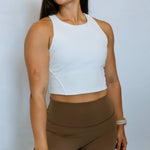 Model wearing The Sweat Society's crop length stretchy tank top.